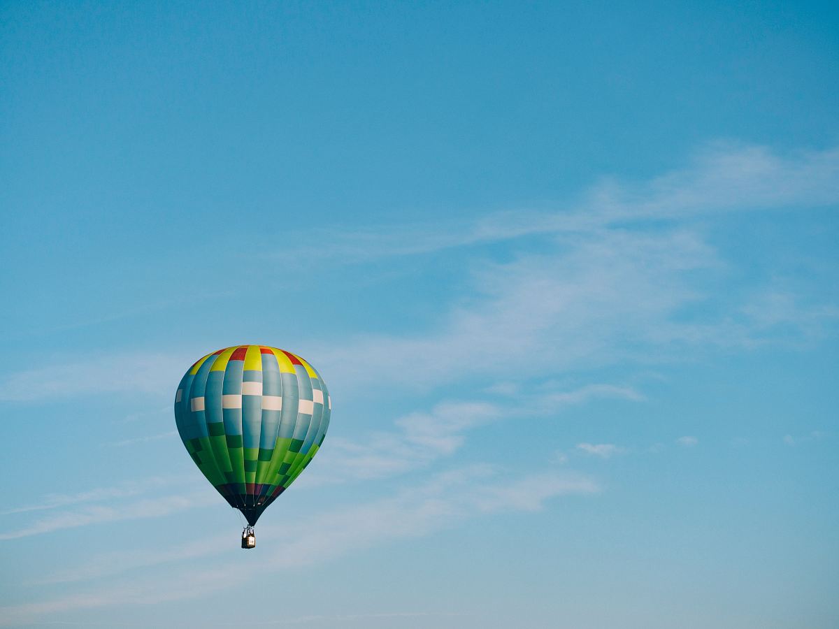 multi-colored hot air balloon flying on sky